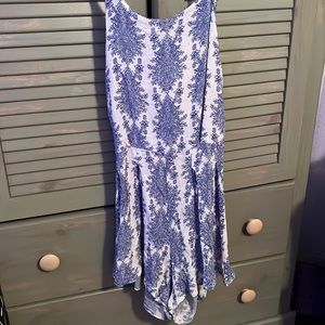 Blue one piece short outfit. Open tie back. Stretchy. Flowy.